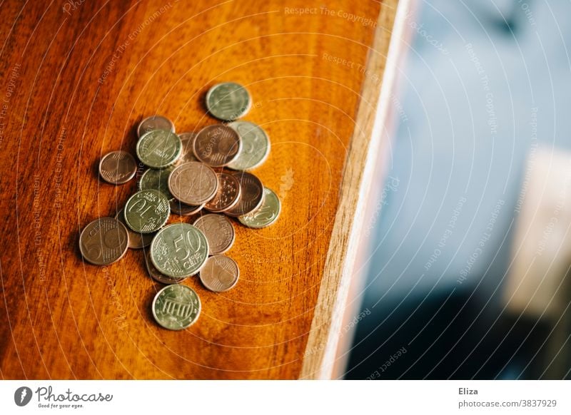 Change is on a table. Money, coins, save. small change Coins Save finance amass Loose change Table Wooden table