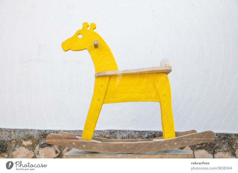 man painting homemade giraffe-shaped rocking horse hobby cabinet-maker cabinet maker polish joiner wooden vintage measure square cabinetmaker woodworker