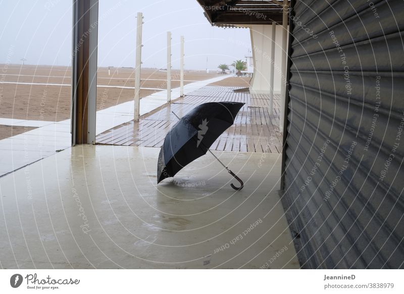 Autumn atmosphere, wet sand, opened umbrella Beach rainy day Empty Italy Deserted Bad weather Exterior shot Wet Rain Rimini Colour photo Nature Autumnal