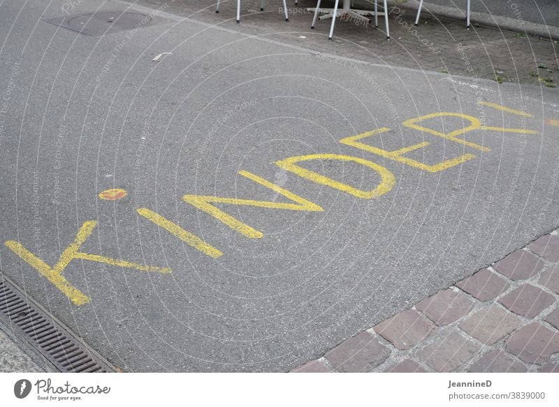 Street with yellow text, kids! lettering Ground Text Word Deserted writing children Yellow Warn esteem Clue Play street Signage painted on Handwriting Caution