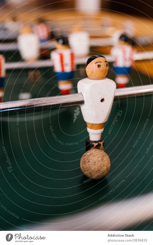 Vintage table football in room soccer game foosball retro vintage old fashioned player figurine nostalgia entertain tradition classic style wooden field green