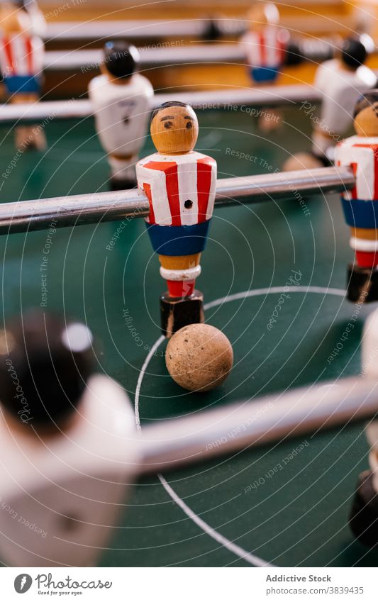 Vintage table football in room soccer game foosball retro vintage old fashioned player figurine nostalgia entertain tradition classic style wooden field green