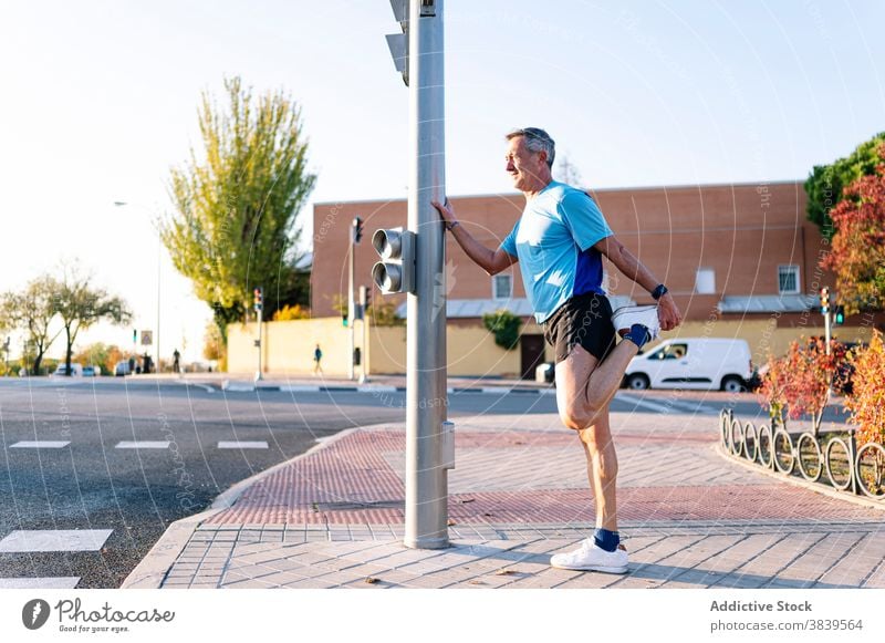 Retired senior man athlete stretching leg 58 rest rythm health care fitness high-blood-pressure training cardiac old neck rate caucasian check sport old man run