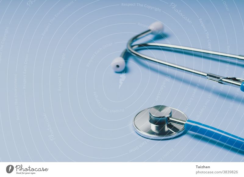 Close-up of Blue stethoscope of doctor for checkup on blue background cardiology disease exam health care medical concept equipment cardiac cardiologist colours