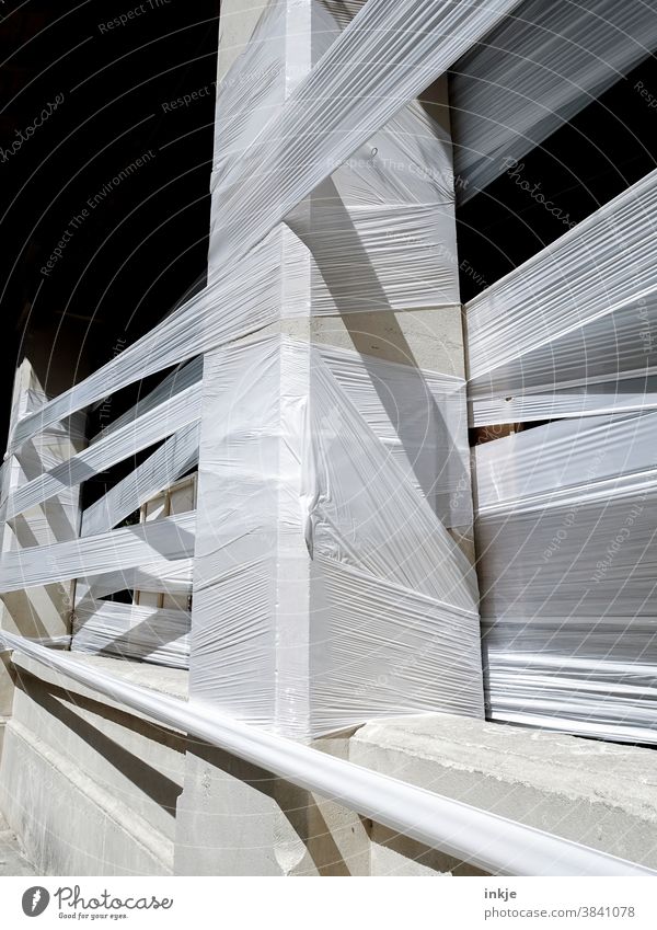 white barrier tape criss-cross Exterior shot Detail Colour photo Contrast White Band Wrapped around locked cordon tight Tense Concrete Facade Building Deserted