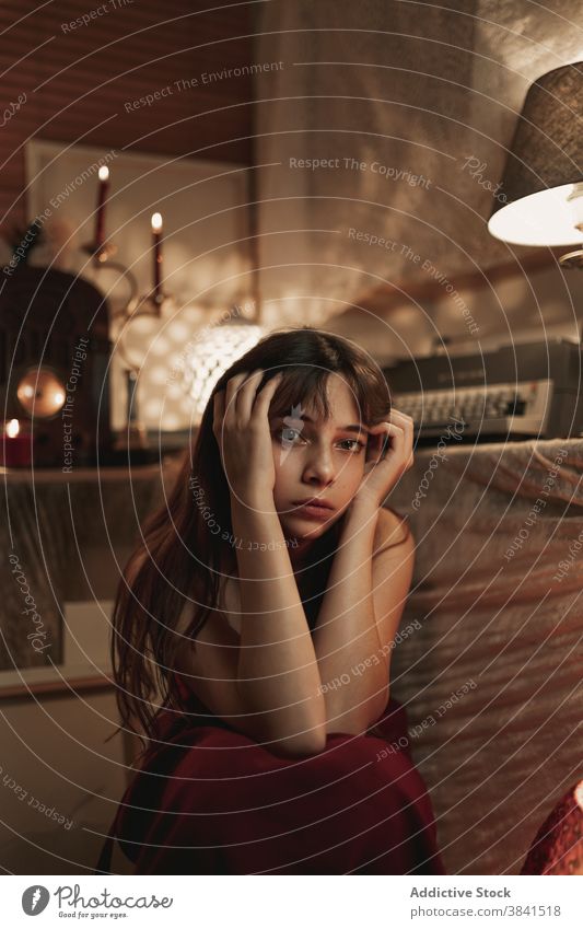 Young woman in cozy room at home atmosphere evening enjoy female old rest calm tranquil serene sit peaceful red dress young lady old fashioned nostalgia metal