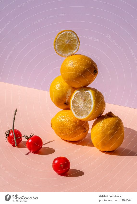 Pile of lemons arranged in studio creative stack composition art fresh sour pile balance pyramid shape natural healthy organic yellow color shadow shade