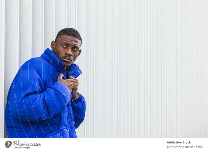 Black stylish man in warm jacket on street style warm clothes handsome outerwear city confident male ethnic black african american vivid blue color fashion