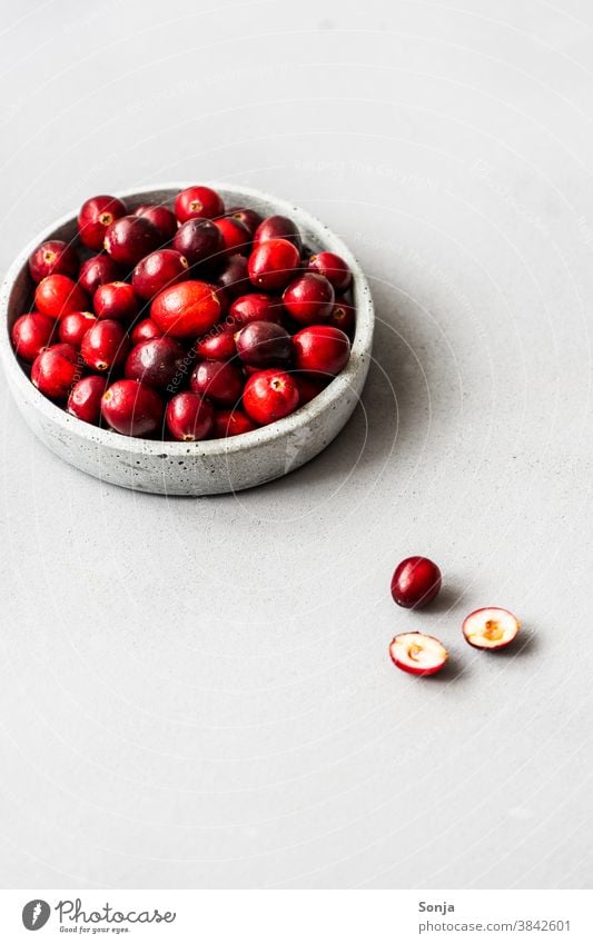 Raw cranberries in a bowl on a grey background. segregated Neutral Background fruit Fresh naturally Delicious Healthy Healthy Eating Organic produce