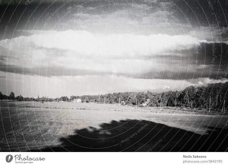 grungy landscape with big tree shadow and massive dark vignette. crooked horizont. Aged Latvia Latvian background country countryside day desert empty famous