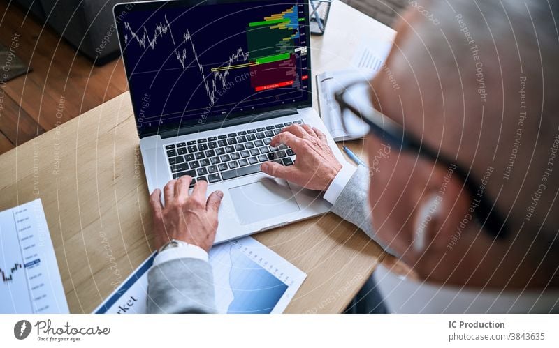 Man looking at computer monitor during working day in office businessman handsome indoors type wireless laptop glasses Caucasian entrepreneur leadership