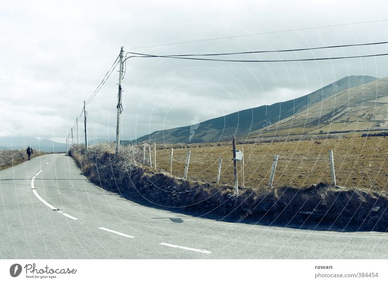 curve Bad weather Meadow Field Street Lanes & trails Cold Gloomy Curve Electricity pylon Cable Telephone cable Mountain Clouds Colour photo Subdued colour