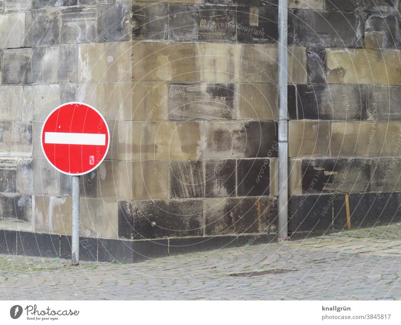 Traffic sign "No entry" at the corner of a house Prohibition sign Signs and labeling Bans Signage Warning sign Exterior shot Colour photo Deserted