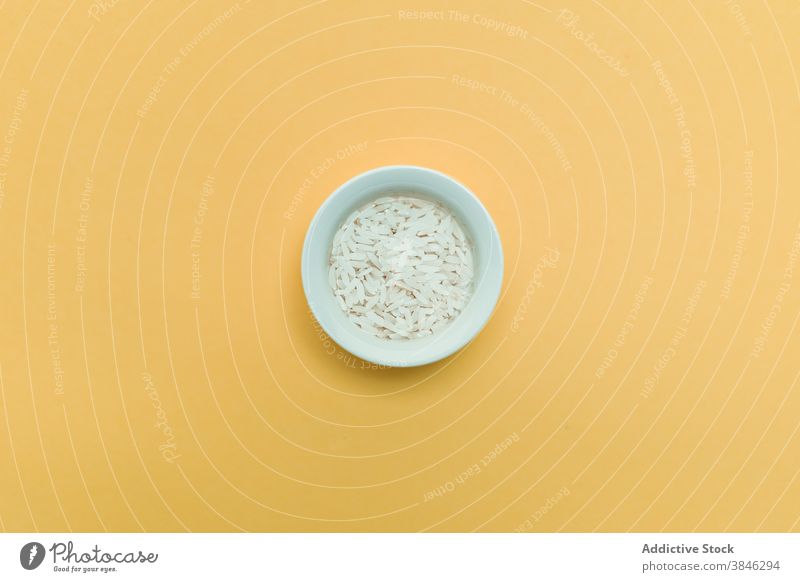 Bowl and rice on yellow background bowl asian food cuisine tradition healthy natural oriental ceramic studio fresh table gourmet organic nutrition uncooked raw