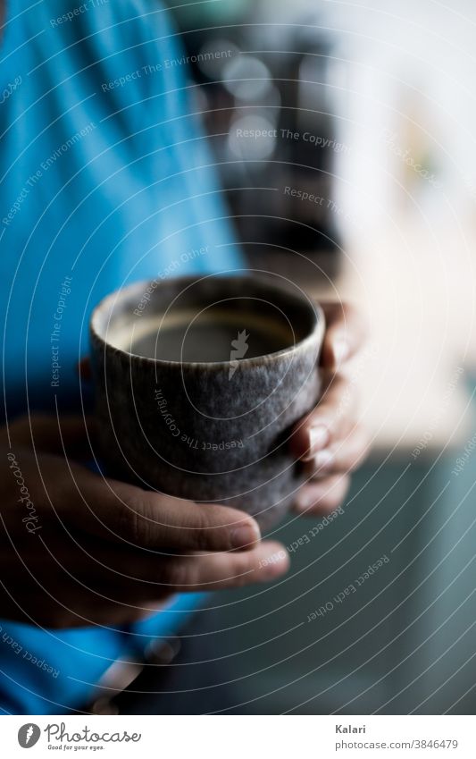 Woman in blue holds individual clay mug with coffee in hand Espresso Coffee Café To enjoy Drinking Coffee cup Coffee break Colour photo Hot Delicious