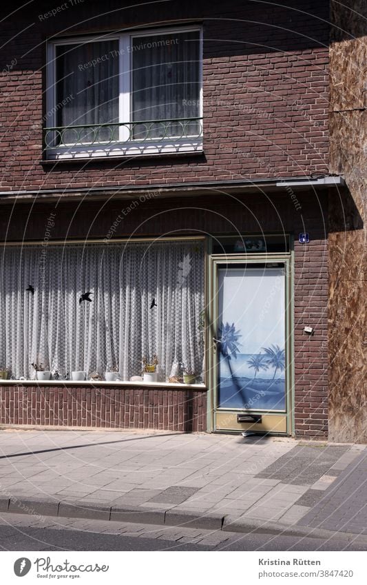 faded beach picture and flower pots Glass door Window Shop window Entrance Drape Curtain Roller blind Poster palms Beach beach scene Bleached flowers