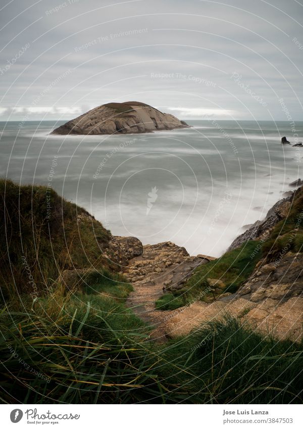 View of Castro Island from Covachos beach. Seascape of the Cantabrian coast. Vertical wallpaper. sea nature rock cliff spain geology water landscape island