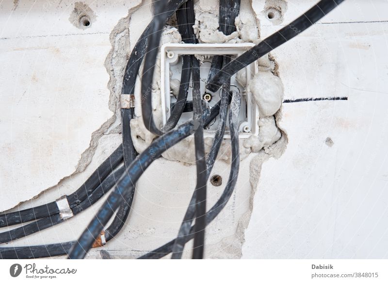 Socket for wiring in a concrete wall. Renovation concept socket cable renovation industry maintenance work system current voltage relay board wire installation