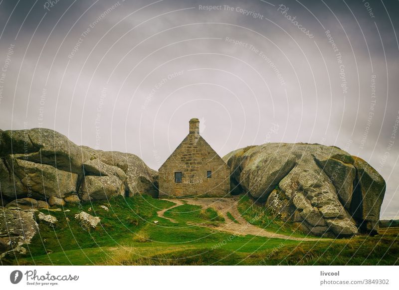 rustic house built between two large stones, france brittany europe clouds season magic home edifice construction architecture awesome grass scene landscape