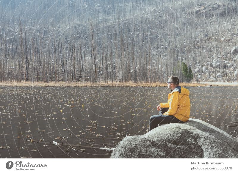 Man enjoying the tranquility at the Cub Lake in the Rocky Mountain National Park, Colorado man tourist hiking relaxing cub lake colorado rocky mountains