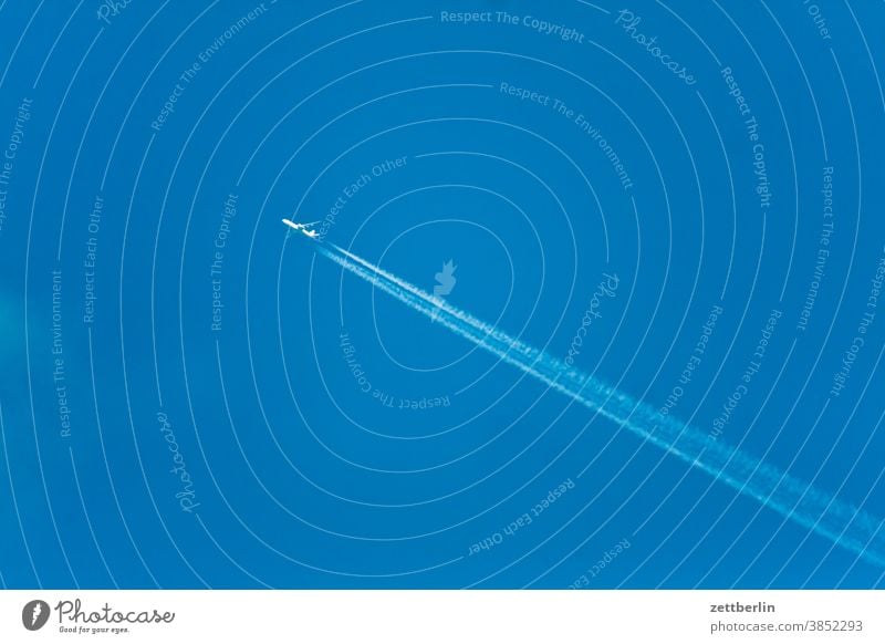 Airplane from bottom right to top left aviator air traffic Flying vacation voyage Long distance travel Vacation holidays Vapor trail chem trail chemical trail