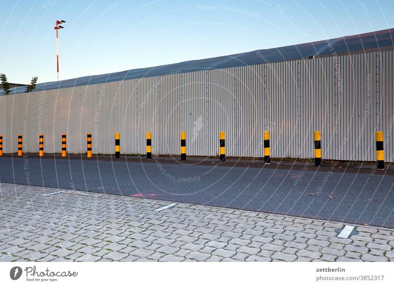 Empty car park in Tegel TXL Evening Berlin Airfield Sky Deserted Street Copy Space Transport Places Parking lot Storage Shed Corrugated sheet iron Road sign