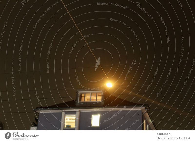 Illuminated house in the dark with power lines House (Residential Structure) Night Dark Lighting stream Cables Power lines Architecture Building Window dwell