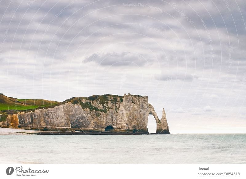 view of the cliff of etretat II, normandy porte daval landscape blue romantic nostalgic blue hour la porte damont coast beach cliffs scene clouds sea seashore