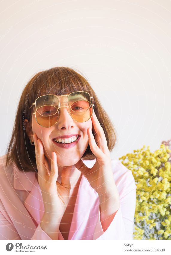 Young woman in pink shirt with sunglasses young fashion accessory autumn spring flowers transparent retro vintage girl brunette face smile fun funny lady wear