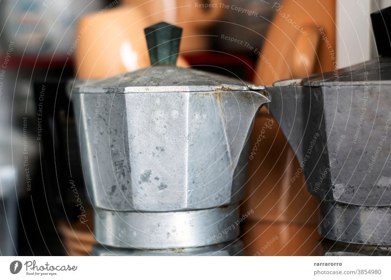 Close-up view of an old coffee pot inside a pantry. moka moka pot coffee maker stainless steel kitchenware espresso espresso maker ruined pour spout handle