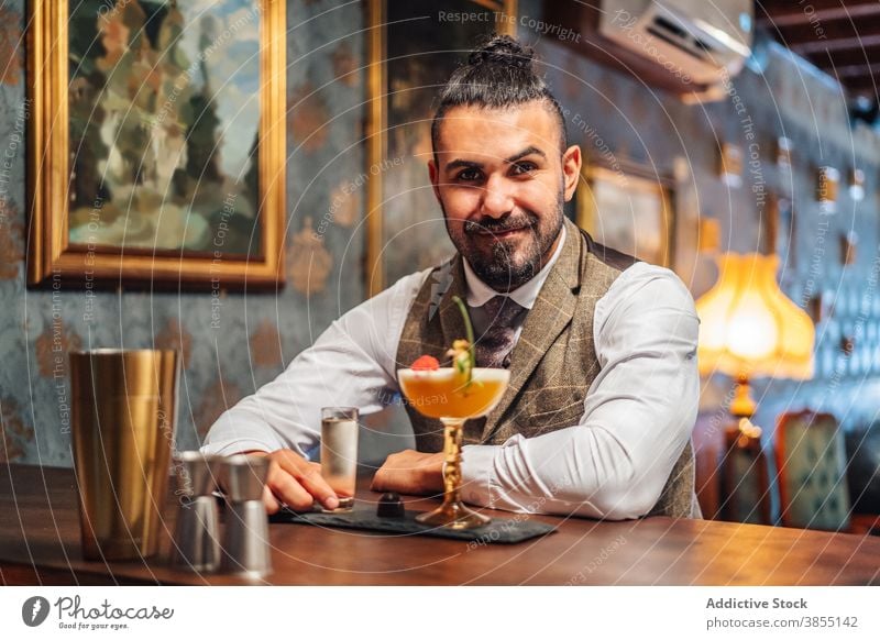 Man enjoying alcohol drinks in pub man bar counter elegant liquor cocktail tropical gentleman club adult male beverage restaurant relax booze service sit lounge