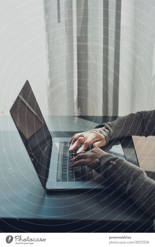 Woman working remotely on her laptop computer managing her work sitting in a cafe business caucasian coffee connection contemplate desk entrepreneur female