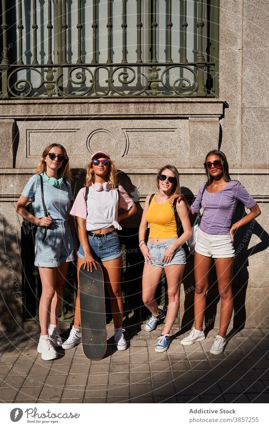 Trendy young women with skateboard in city friend group urban trendy together happy teenage cheerful girl sunglasses longboard girlfriend cool millennial skater