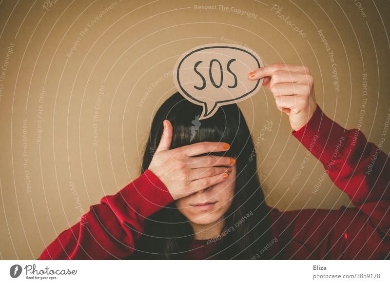 One woman holds her hand in front of her eyes and holds up a speech bubble with the inscription SOS Help Emergency call peril Emergency situation First Aid