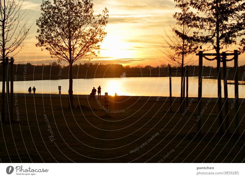 Romantic atmosphere at the lake at sunset. Walkers at the lake. Landscape Sunset Lake romance Autumn strollers Clouds Sky Nature Evening Dusk Water Relaxation