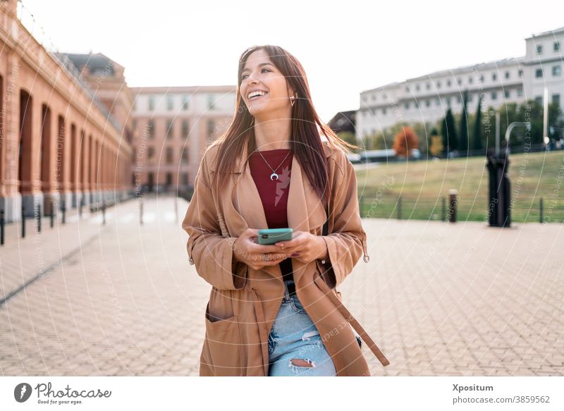 Young caucasian woman using smartphone laughing happy people madrid portrait city lifestyle young urban travel beautiful happiness smile spain mobile person