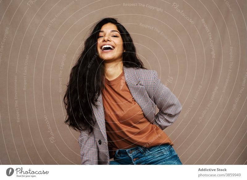 Cheerful woman in stylish wear in studio style jacket trendy laugh cheerful having fun model charming female ethnic happy young pleasure relax optimist modern