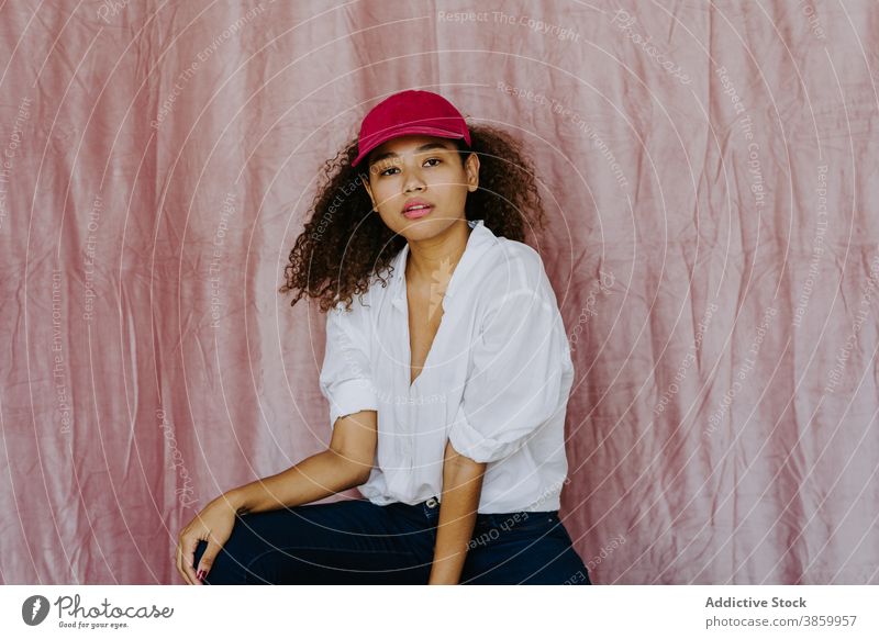 Young ethnic woman in trendy outfit style fashion cap confident afro casual cloth millennial female african american black headwear young individuality brunette