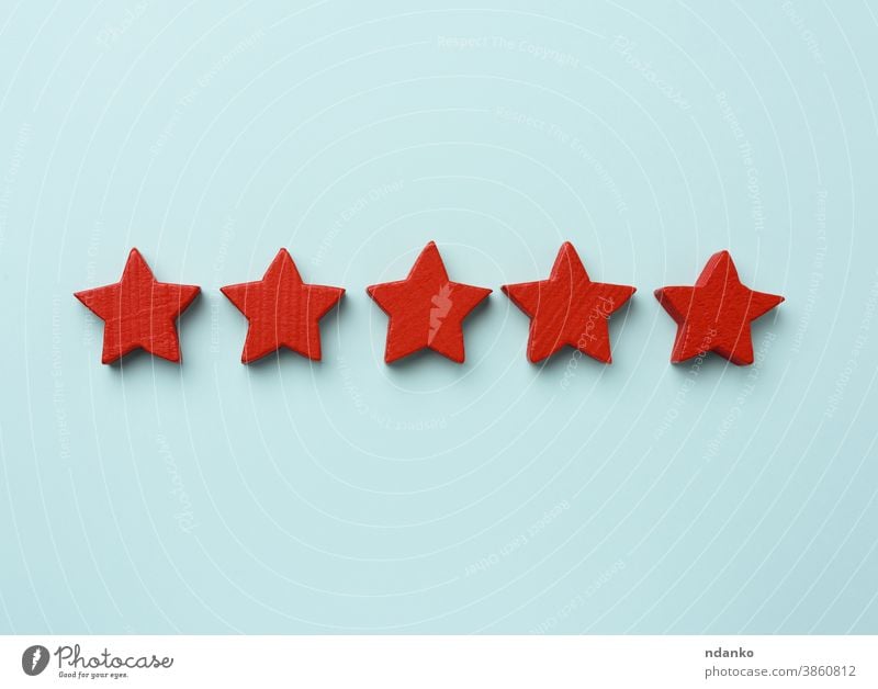 five red wooden stars on a blue background, high score review excellence sign concept marketing ranking rating best quality service success satisfaction