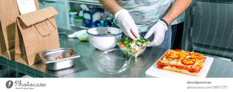 Unrecognizable cook preparing takeaway orders unrecognizable chef preparing orders salad industrial kitchen package gloves hygiene take away banner web header