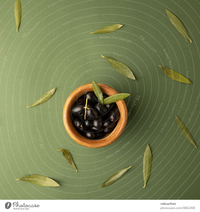 black olives, on green background fresh healthy food leaf ingredient greek organic vegetarian extra oil yellow fruit spain plant closeup raw natural virgin