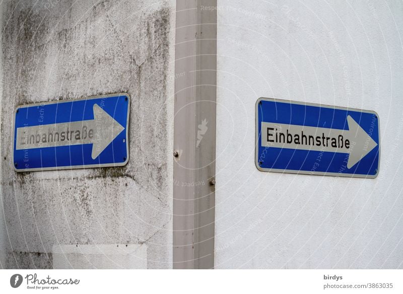 One-way street signs at the corner of a house. One-way street Signs and labeling Road sign 2 house corner groundbreaking symbolic to the right Right Arrow