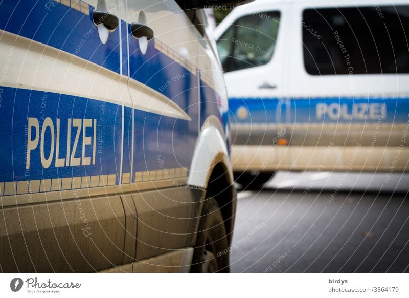 Two police vehicles block a road. Tubs, police cars with inscription Police Police Force Police vehicles Transporter Inscription executive Police car polluted