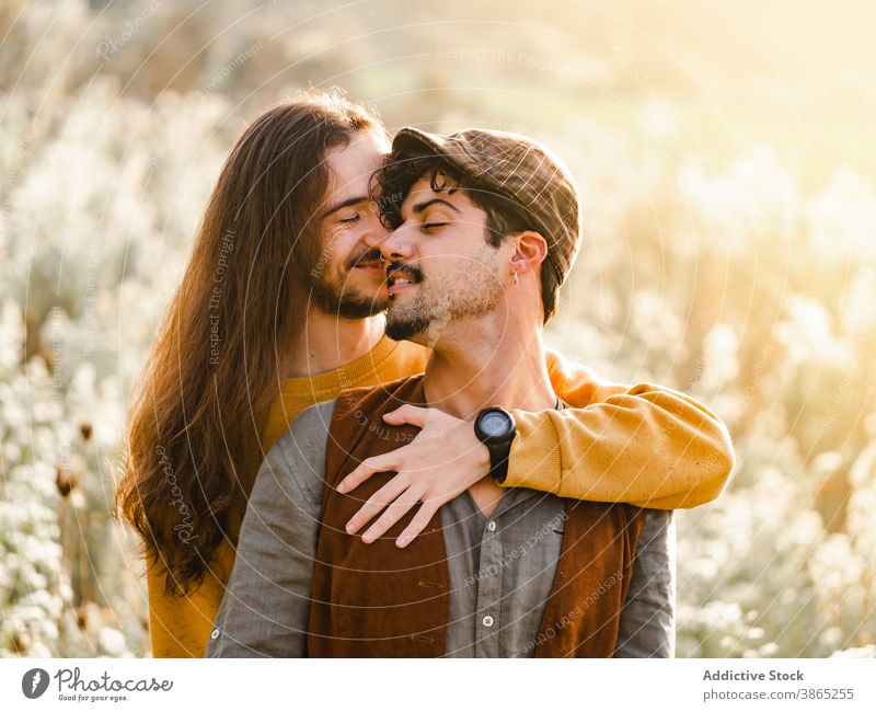 Happy gay couple hugging in nature homosexual men love embrace passion intimate romantic relationship lgbt young happy ethnic male together affection tender