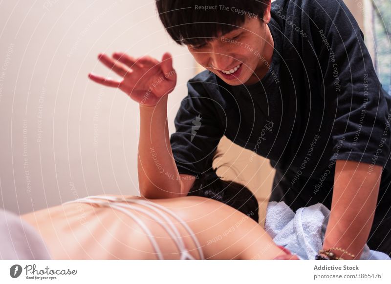 Masseur putting cubit on client while doing rehabilitation massage in professional salon masseur patient treat care therapy procedure wellness healthy wellbeing