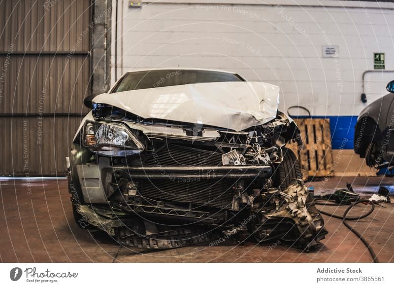 Crashed car inside spacious garage crash professional damage parked front modern maintenance service auto fix workshop repair transport vehicle industry wreck