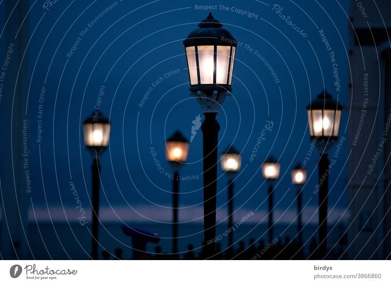 stylish lighting at night. bright street lamps. night shot read Lighting Style Lamp Illuminate Night Horizon Night sky Shallow depth of field in a row