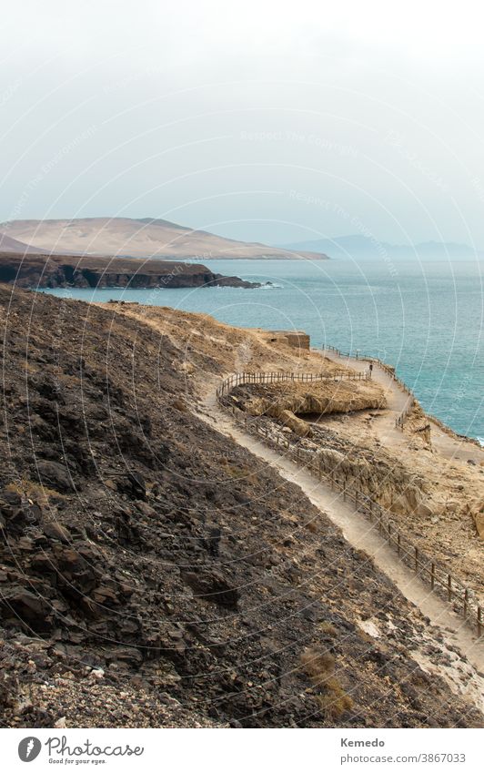 Landscape of a path between the mountains and the ocean in Ajuy, Fuerteventura (Canary islands), Spain. sea landscape fuerteventura ajuy spanish canary islands