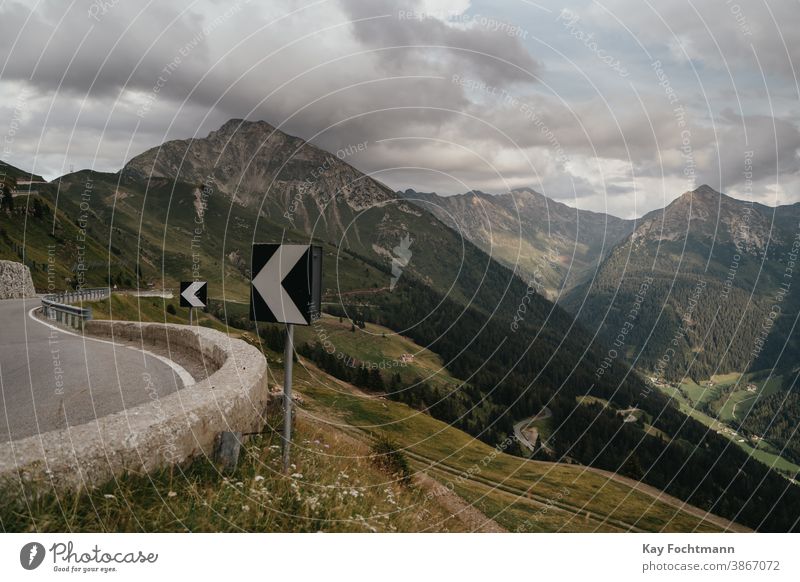 scenic mountain road with curve signs alp alpine alps asphalt austria car country curved day driving empty europe european highway hill holiday horizontal