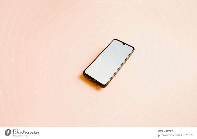 Flat pink background with a mobile phone with a white screen and copy space to write on phones copy-space selection tech listen multimedia workplace middle